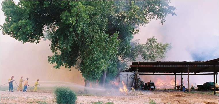 Emergency responder reviewing a burned residential area in New Mexico